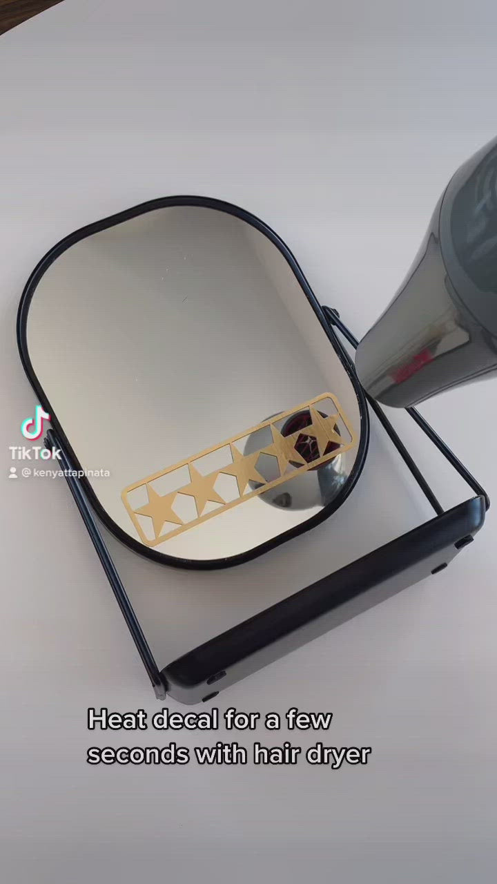 How to remove mirror decal without damage for renters in Tiktok video demo. Gold 5 star mirror decal for daily positive affirmation. Mirror affirmation decal placed on modern black mirror for bathroom. Black mirror for bathroom has a tray for skincare products.