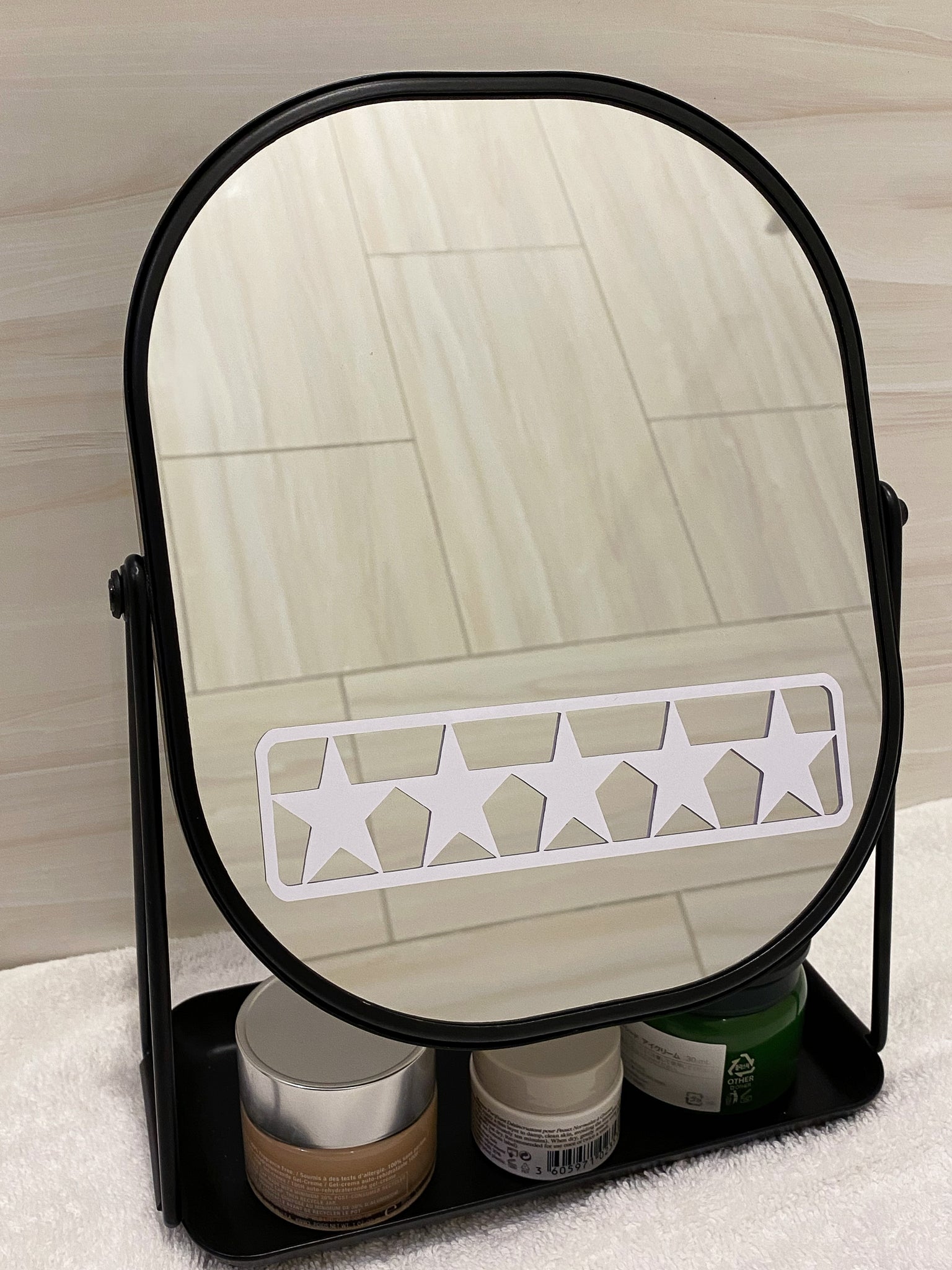 White 5 star mirror decal for daily positive affirmation. Mirror affirmation decal placed on modern black mirror for bathroom. Black mirror for bathroom has a tray for skincare products.