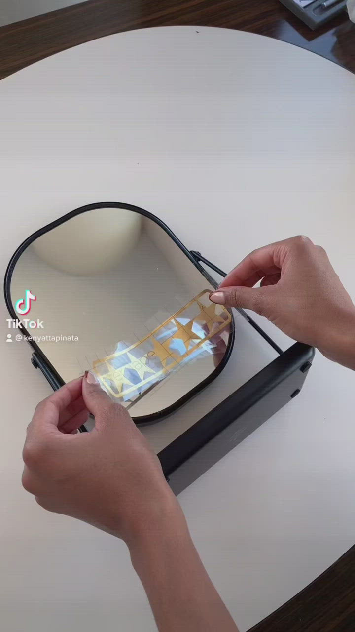 How to apply mirror decal without air bubbles in Tiktok video demo. Gold 5 star mirror decal for daily positive affirmation. Mirror affirmation decal placed on modern black mirror for bathroom. Black mirror for bathroom has a tray for skincare products.